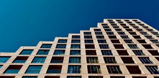 A modern high-rise building in Eindhoven, Netherlands with a clear blue sky backdrop.