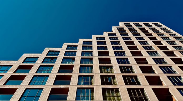 A modern high-rise building in Eindhoven, Netherlands with a clear blue sky backdrop.
