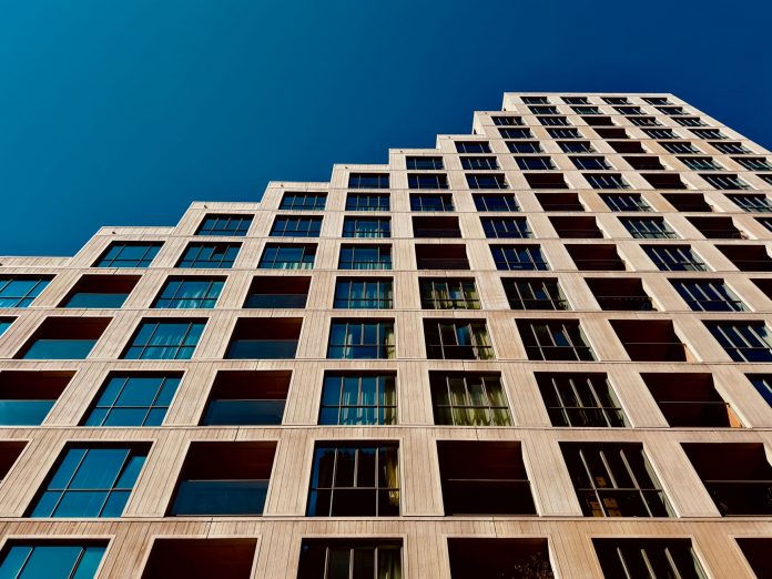 how-to-find-apartment-north-bergen-2026 A modern high-rise building in Eindhoven, Netherlands with a clear blue sky backdrop.