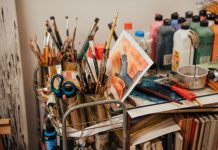 Colorful art studio corner with brushes, paints, and a painted canvas. Ideal for creative inspiration.