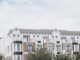 Hudson House West and Radio Lofts Bring Spacious Luxury to Jersey City A stylish, multi-story luxury apartment building with a contemporary facade against a clear sky.