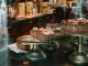 Tempting chocolate cakes with decorations on display in a cozy cafe setting.