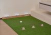 Indoor Golf and Bar Coming to Powerhouse Arts District Indoor putting green with golf balls and equipment for golf practice at home.