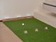 Indoor Golf and Bar Coming to Powerhouse Arts District Indoor putting green with golf balls and equipment for golf practice at home.