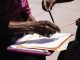 Close-up of hands exchanging documents with pens outdoors. Business agreement concept.