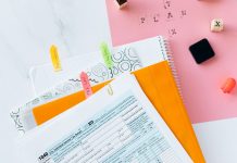 Overhead view of tax documents, forms, and organized work area for tax preparation.