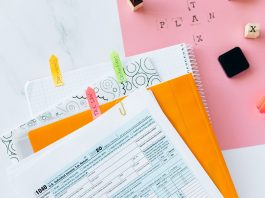 Overhead view of tax documents, forms, and organized work area for tax preparation.