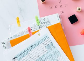 Overhead view of tax documents, forms, and organized work area for tax preparation.