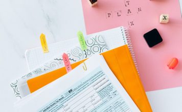 Overhead view of tax documents, forms, and organized work area for tax preparation.