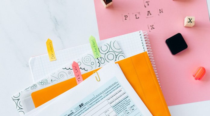 Jersey City Tax Hike Is Mandatory, State Says Overhead view of tax documents, forms, and organized work area for tax preparation.