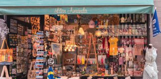 A colorful display of Swedish souvenirs in a quaint shopfront in Stockholm's Gamla Stan district.