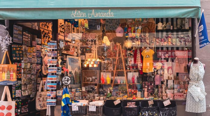 A colorful display of Swedish souvenirs in a quaint shopfront in Stockholm's Gamla Stan district.