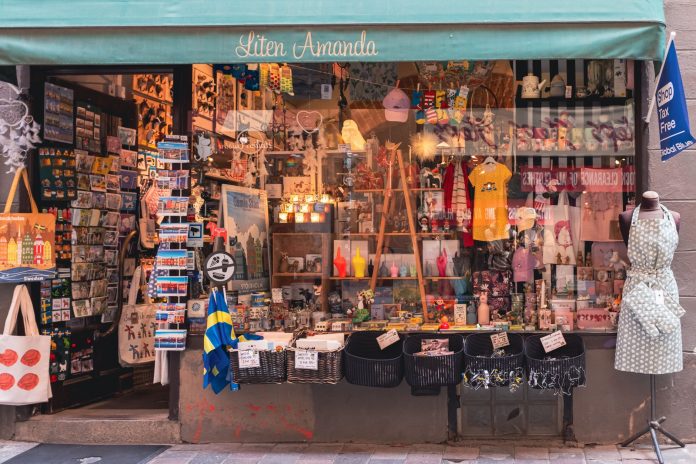 A colorful display of Swedish souvenirs in a quaint shopfront in Stockholm's Gamla Stan district.