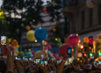 Jersey City Tower Wi-Fi Collapses Under Event Crowds A lively crowd captures a festive street scene filled with colorful balloons and vibrant energy.