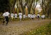 A group of kids participating in a running event in a leafy park in Bursa, Türkiye.
