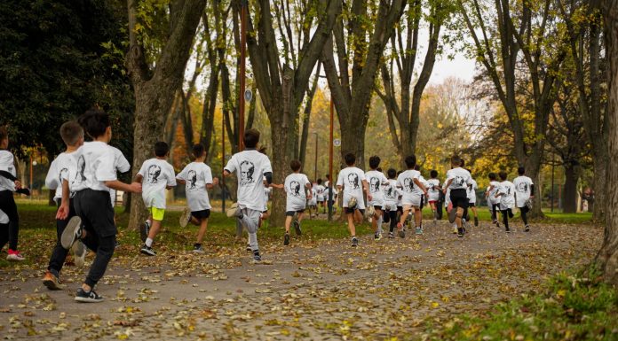 A group of kids participating in a running event in a leafy park in Bursa, Türkiye.