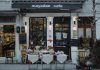 An inviting outdoor café showcasing local food, menu boards, and charming decorations in a quaint neighborhood setting.