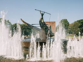 A striking bronze statue at the Sandefjord Whalers Monument fountain in Norway's urban park.