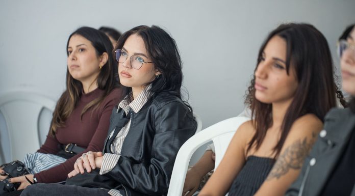 Focused individuals attending an indoor seminar, showcasing engagement and learning.