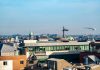 A vibrant view of Dublin's cityscape featuring construction cranes and iconic architecture under a clear blue sky.