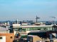 A vibrant view of Dublin's cityscape featuring construction cranes and iconic architecture under a clear blue sky.