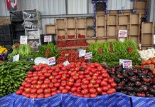 Fresh produce at a bustling Istanbul market showcasing tomatoes, peppers, and more.