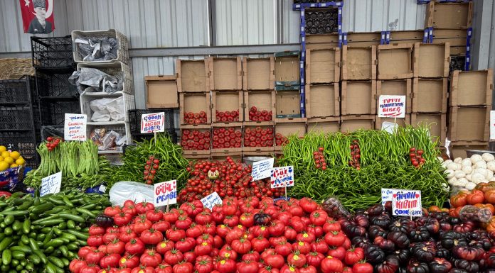 Fresh produce at a bustling Istanbul market showcasing tomatoes, peppers, and more.