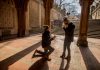 A couple shares a marriage proposal moment under Bethesda Terrace, Central Park.