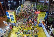Vivid start of a midnight marathon in Ho Chi Minh City with a large crowd.