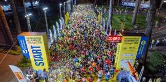 Vivid start of a midnight marathon in Ho Chi Minh City with a large crowd.