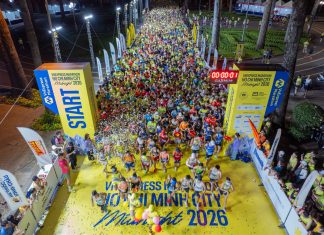 Vivid start of a midnight marathon in Ho Chi Minh City with a large crowd.