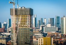 Aerial view of modern skyscrapers in Manchester with ongoing construction highlighting urban growth.