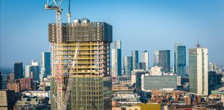 Aerial view of modern skyscrapers in Manchester with ongoing construction highlighting urban growth.