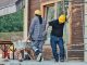 ÚLTIMA HORA: Sindicatos demandan por robo de salario en torres de Journal Square Two construction workers wearing hard hats work at an outdoor site, one with a wheelbarrow.