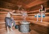 Three people enjoying a steamy sauna session, embracing wellness and relaxation.