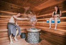 Three people enjoying a steamy sauna session, embracing wellness and relaxation.