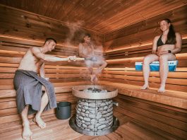 Three people enjoying a steamy sauna session, embracing wellness and relaxation.