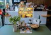 Charming cafe interior in Ankara featuring a variety of pastries and drinks on display.
