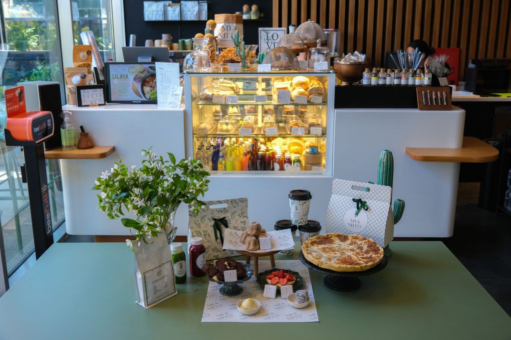 Charming cafe interior in Ankara featuring a variety of pastries and drinks on display.