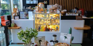 Charming cafe interior in Ankara featuring a variety of pastries and drinks on display.