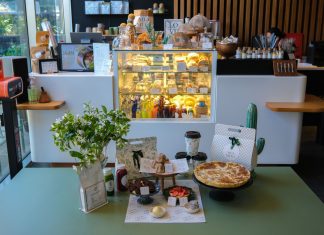 Charming cafe interior in Ankara featuring a variety of pastries and drinks on display.
