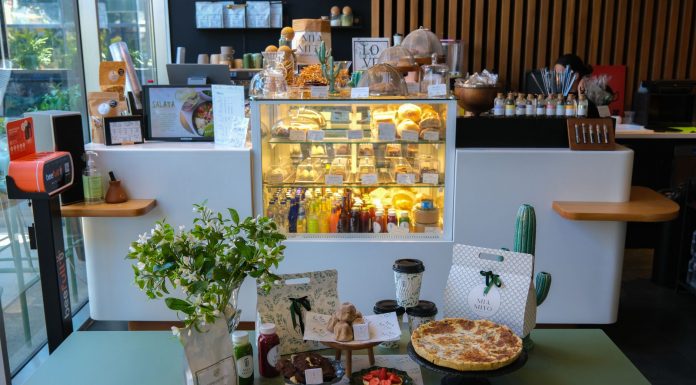Charming cafe interior in Ankara featuring a variety of pastries and drinks on display.