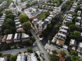 Drone shot capturing a scenic Philadelphia neighborhood with a prominent church at the center.