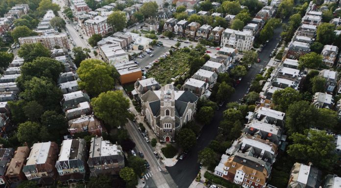 Drone shot capturing a scenic Philadelphia neighborhood with a prominent church at the center.