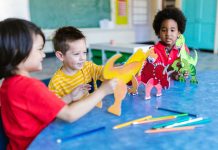 Three kids playing with dinosaur figures, fostering imagination and learning.