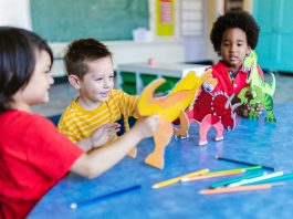 Three kids playing with dinosaur figures, fostering imagination and learning.