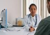 Los Mejores Médicos y Clínicas en Bayonne, NJ (Guía 2026) A female doctor consulting a patient in a modern medical office setting.