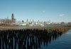 Scenic view of New York City skyline from Hoboken waterfront with wooden piers in the foreground.