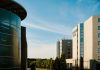 Contemporary hotel architecture with blue sky backdrop in city environment.
