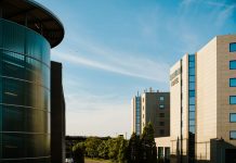 Contemporary hotel architecture with blue sky backdrop in city environment.